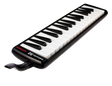 The image shows a Hohner Instructor 32 melodica, a wind instrument with a 32-key piano-style keyboard. It has a black plastic body, a mouthpiece with tube for blowing air, and Hohner branding. Designed for music education, it combines harmonica and keyboard elements, producing a unique sound ideal for students learning breath control and keyboard skills.