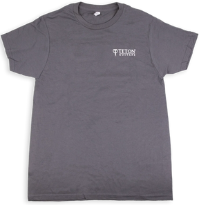 The image shows a gray t-shirt with the "Teton Guitars" logo printed in white on the chest. This branded apparel is merchandise from Teton Guitars, a company known for producing acoustic guitars. The shirt likely serves as promotional or fan gear, representing the type of merchandise musical instrument manufacturers create to promote their brand and generate additional revenue.