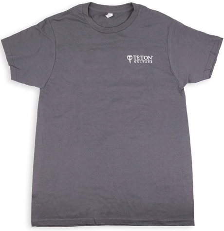The image shows a gray t-shirt with the "Teton Guitars" logo printed in white on the chest. This branded apparel is merchandise from Teton Guitars, a company known for producing acoustic guitars. The shirt likely serves as promotional or fan gear, representing the type of merchandise musical instrument manufacturers create to promote their brand and generate additional revenue.