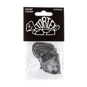 A package with a plastic bag filled with black 'Dunlop' branded guitar picks on a white background