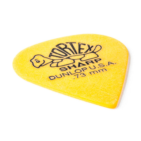 A yellow 'Dunlop' branded guitar pick with a turtle design on a white background