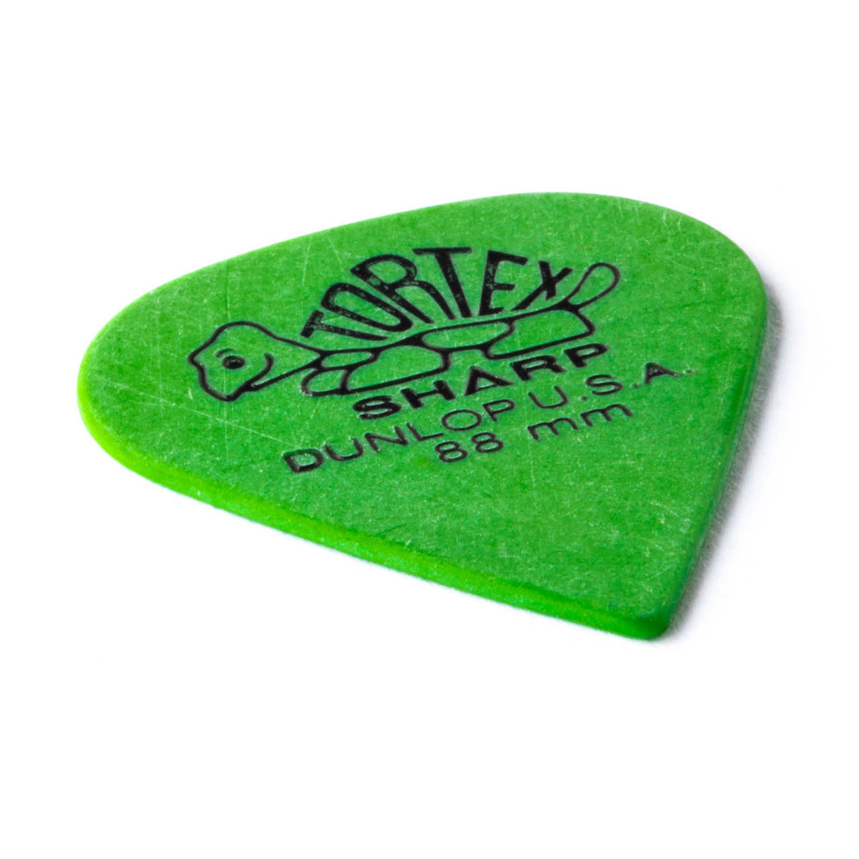 A green 'Dunlop' branded guitar pick with a Tortex turtle design on a white background
