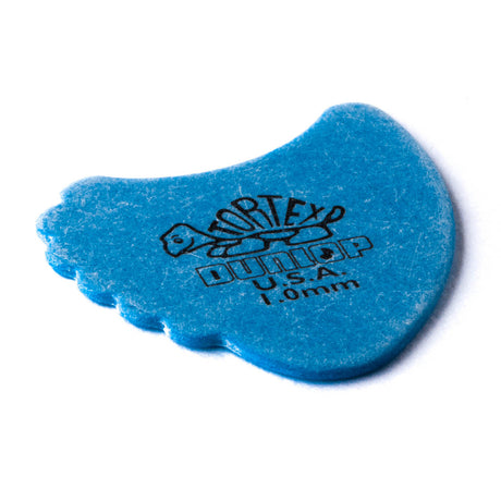 A blue 'Dunlop' branded fin guitar pick with a Tortex turtle design on a white background