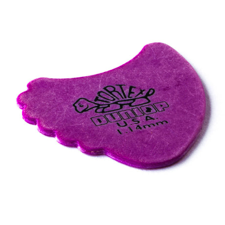 A purple 'Dunlop' branded fin guitar pick with a Tortex turtle design on a white background