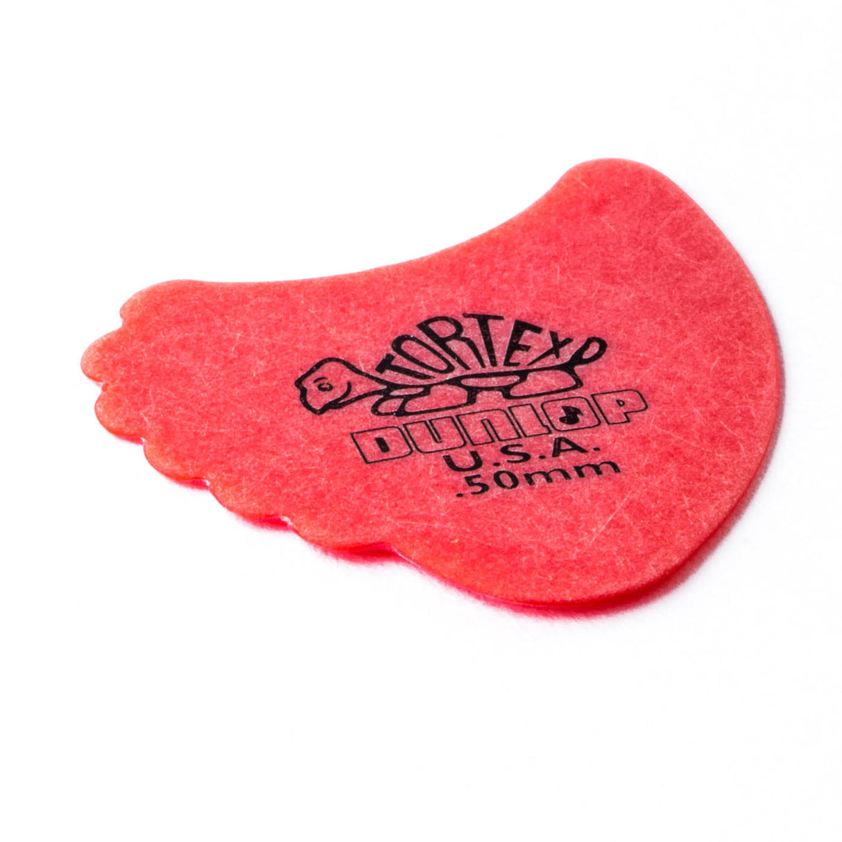 A red 'Dunlop' branded fin guitar pick with a Tortex turtle design on a white background