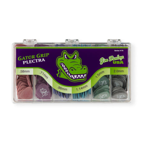 A plastic box filled with Jim Dunlop Gator Grip assorted guitar picks on a white background