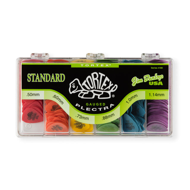 Box of Dunlop Tortex guitar picks with various sizes on a white background