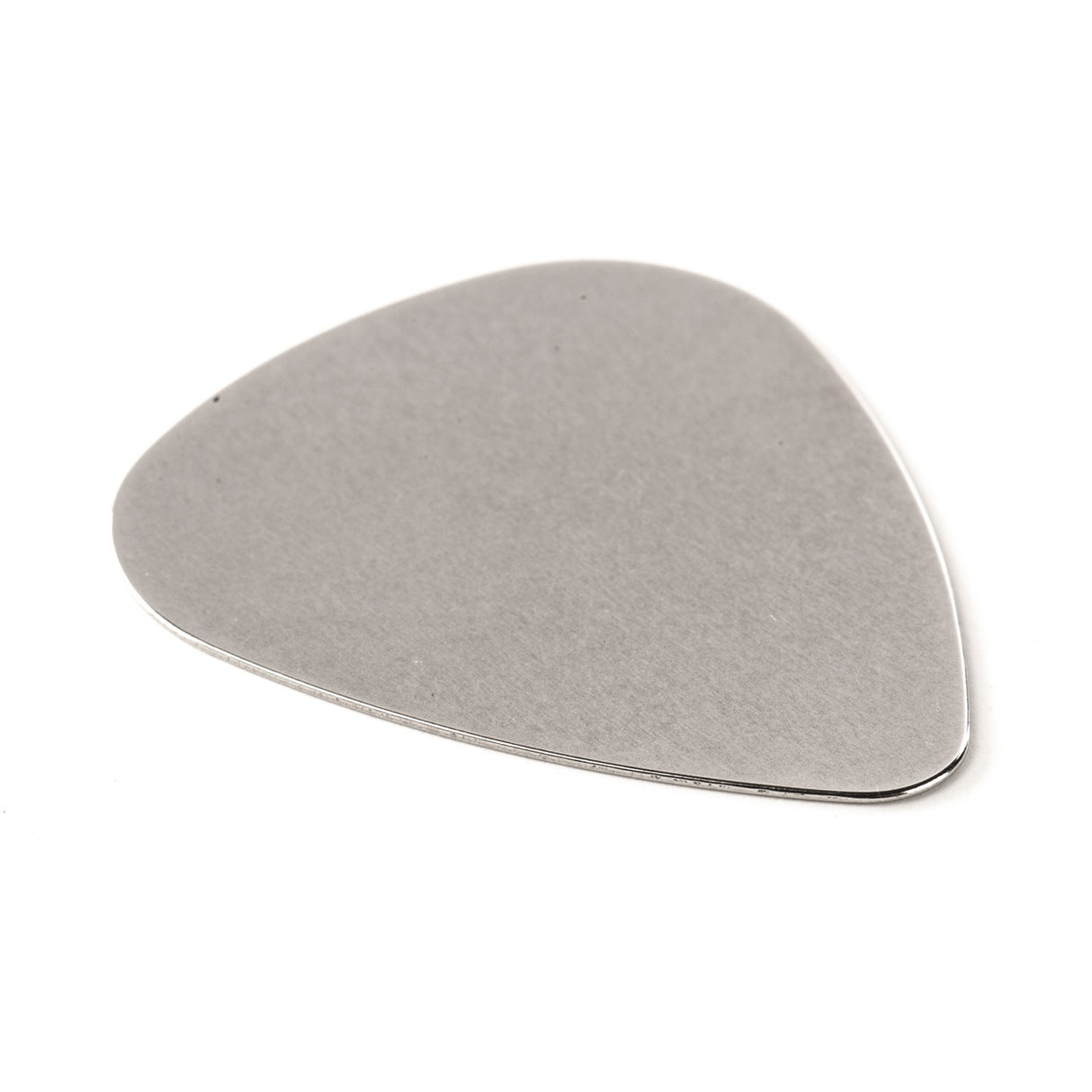A stainless steel guitar pick on a white background