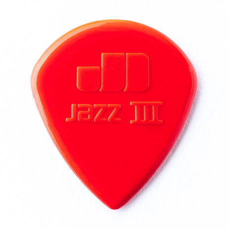 A red guitar pick with Jazz III engraving on a white background