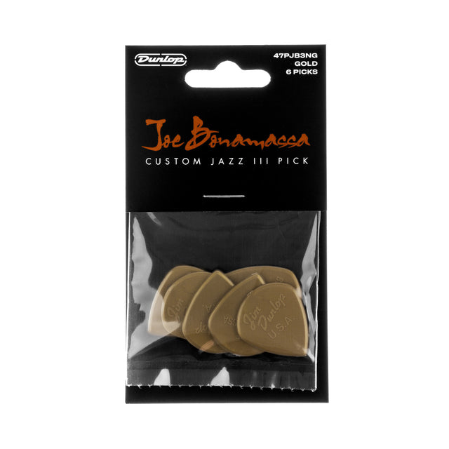 Pack of Dunlop Joe Bonamassa Custom Jazz III guitar picks in gold color on a clear background.