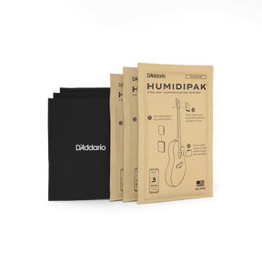 The image shows three kraft paper packages of D'Addario Humidipak Two-Way Humidification System and three black D'Addario-branded storage pouches. This system helps maintain optimal humidity levels in acoustic guitars and wooden stringed instruments, preventing damage from moisture fluctuations. It’s a popular accessory for guitar care, ensuring instrument longevity, playability, and sound quality.