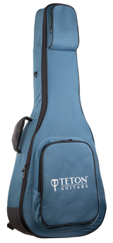 The image shows a blue Teton Guitars padded gig bag for acoustic guitars, featuring black trim, the "TETON GUITARS" logo on the front pocket, multiple compartments for accessories, padded shoulder straps, and a full-length zipper. Made from durable nylon-like material, it offers lightweight, protective transport ideal for Teton and most standard acoustic guitars.