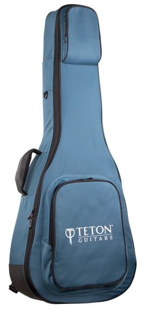 The image shows a blue Teton Guitars padded gig bag for acoustic guitars, featuring black trim, the "TETON GUITARS" logo on the front pocket, multiple compartments for accessories, padded shoulder straps, and a full-length zipper. Made from durable nylon-like material, it offers lightweight, protective transport ideal for Teton and most standard acoustic guitars.