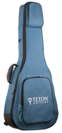 The image shows a blue Teton Guitars padded gig bag for acoustic guitars, featuring black trim, the "TETON GUITARS" logo on the front pocket, multiple compartments for accessories, padded shoulder straps, and a full-length zipper. Made from durable nylon-like material, it offers lightweight, protective transport ideal for Teton and most standard acoustic guitars.