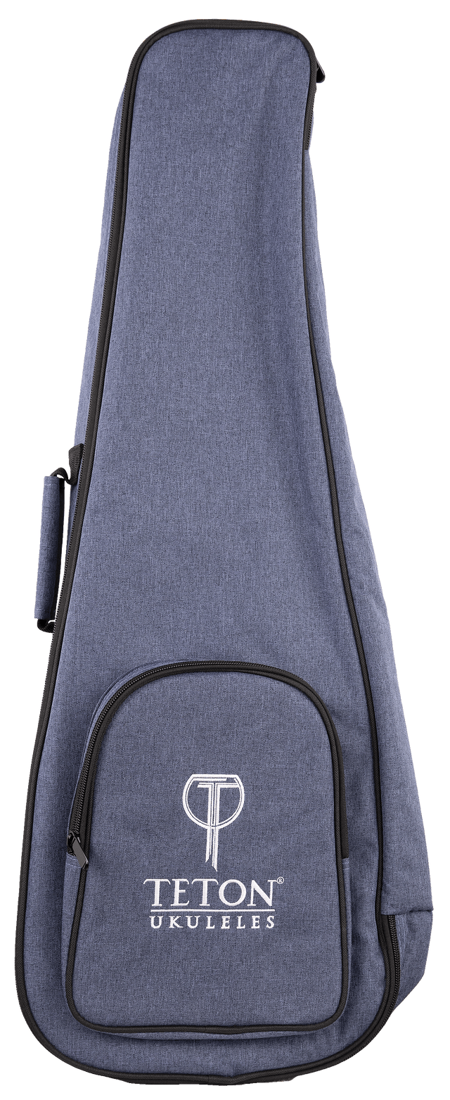 The image shows a TETON Music ukulele gig bag made of blue denim-like fabric with black trim. It features the "TETON UKULELES" logo on the front zippered pocket. The padded soft case includes a main compartment for a ukulele, accessory storage, carrying handles, shoulder strap capability, and a full-length zipper for easy access, offering stylish, practical protection for the instrument.