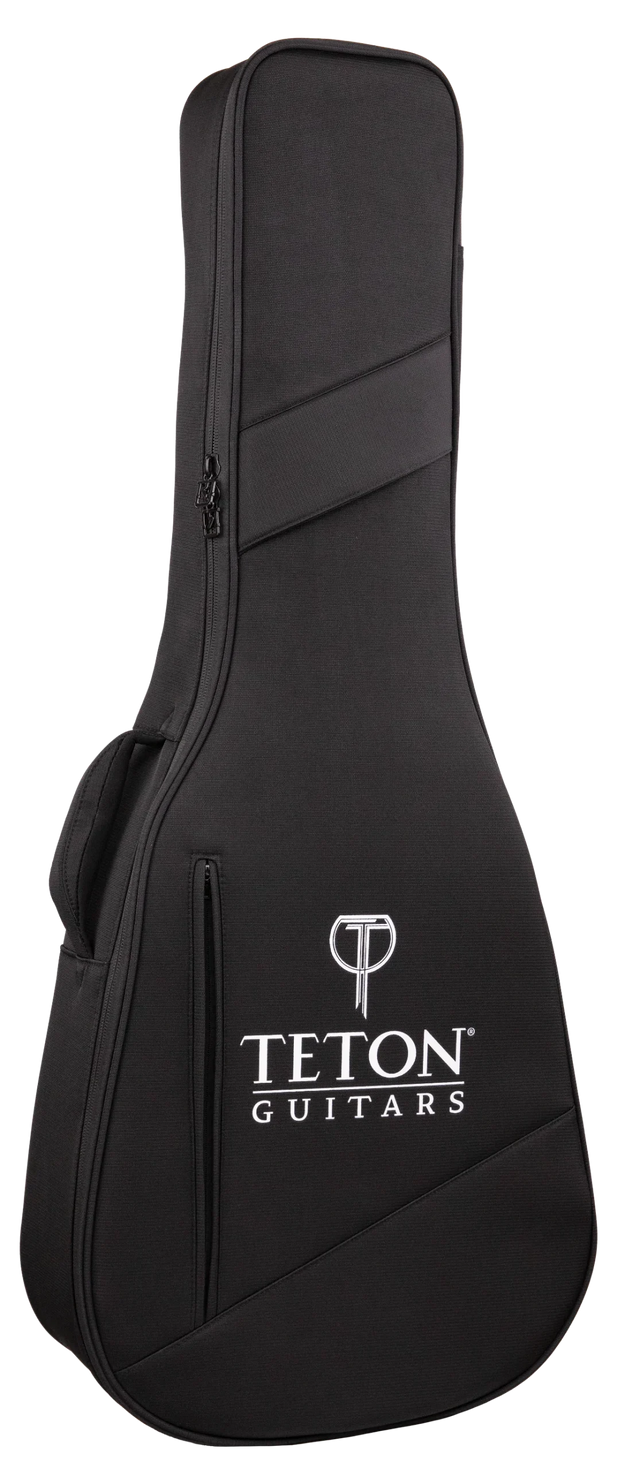 The image shows a black Teton Guitars soft guitar gig bag with a textured fabric surface, white Teton logo and brand name, and a "T" logo at the top. It features diagonal accent stripes, a full-length zipper, and padded shoulder straps. Designed for acoustic guitars, it offers lightweight, portable protection with a sleek, professional look.