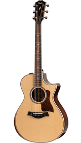 The image shows a high-quality Taylor acoustic guitar with a Grand Auditorium cutaway body. It features a natural spruce top with a glossy finish, dark rosewood back and sides, and a dark wood fretboard with abalone inlays. Chrome tuning pegs, a tortoiseshell pickguard, and acoustic-electric electronics are visible. The guitar has elegant binding, a 6-string steel configuration, and professional-grade craftsmanship typical of Taylor’s higher-end models.