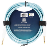 The image shows a coiled Teton TGC10 guitar cable with a light blue/turquoise braided jacket and gold-plated 1/4" jacks on both ends. It features black velcro straps for cable management and a circular info card. Designed for clear, noise-free sound, it has a 6.5mm outer jacket and comes with a 1-year limited warranty. Made by Chesebro Music Company, Idaho Falls, Idaho, this professional-grade instrument cable suits guitars, basses, and audio gear.