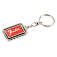 The image shows a metal Fender keychain with a rectangular design featuring the red Fender logo on a dark background, framed by chrome-colored metal. It includes a standard key ring attached by a small chain link. This branded accessory represents Fender, a renowned guitar and amplifier manufacturer popular among musicians and fans.