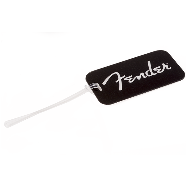 The image shows a black luggage tag featuring the white cursive "Fender" logo. Fender is a well-known brand in musical instruments, famous for electric guitars like the Stratocaster and Telecaster. The tag has a white cord for attaching to instrument cases or bags, serving as both a practical identifier and a way for musicians to display their brand loyalty.