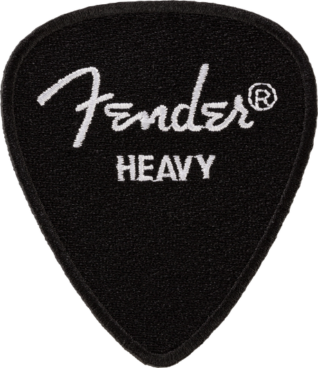 The image shows a black Fender guitar pick with a textured surface and the white Fender logo along with the registered trademark symbol. It is marked "HEAVY," indicating a thicker pick preferred for rigidity and control, popular among lead guitarists and single-note players. Fender is a well-known brand in guitars and accessories.