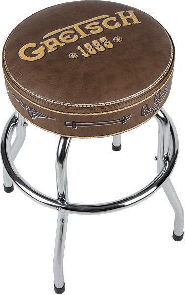 The image shows a Gretsch-branded bar stool with a round brown leather seat featuring the "Gretsch" logo and "1883" in gold lettering. It has chrome metal legs, decorative stitching, and small Gretsch logo details on the seat edges. This music-themed stool is branded merchandise designed for musicians or fans, typically used in studios or performance spaces to showcase the iconic Gretsch brand.