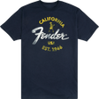 The image shows a navy blue Fender t-shirt featuring the iconic Fender logo. The design includes yellow "CALIFORNIA" text, the classic white Fender script, a small vintage-style skeleton guitarist graphic, "USA," and "EST. 1946." This branded apparel represents Fender, a legendary guitar and amplifier maker founded in California in 1946, popular among musicians and music fans.