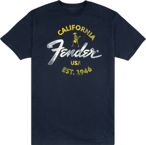 The image shows a navy blue Fender t-shirt featuring the iconic Fender logo. The design includes yellow "CALIFORNIA" text, the classic white Fender script, a small vintage-style skeleton guitarist graphic, "USA," and "EST. 1946." This branded apparel represents Fender, a legendary guitar and amplifier maker founded in California in 1946, popular among musicians and music fans.