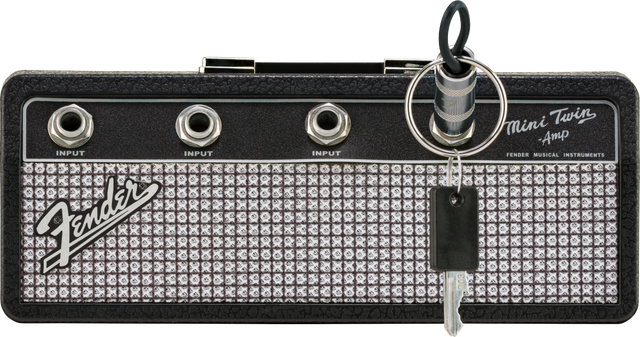The image shows a compact Fender Mini Twin Amp keychain styled like a miniature guitar amplifier head. It features the Fender logo, “Mini Twin Amp” text, three 1/4" input jacks labeled "INPUT," and classic Fender design with silver sparkle grille and black tolex. This small, portable item resembles Fender’s Twin Reverb amps and is often used as a collectible, practice tool, or novelty accessory.