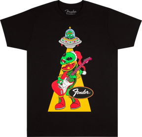 The image shows a black Fender t-shirt featuring a whimsical green alien wearing a Santa hat, playing a Fender Stratocaster guitar. The alien is being "abducted" by a UFO via a tractor beam. The classic Fender logo appears below the cartoon-style design. This playful, holiday-themed shirt combines Fender’s iconic guitar branding with sci-fi and festive elements, popular among musicians and guitar fans.