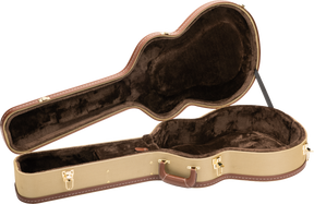 The image shows an open hard shell guitar case with a tan tweed exterior and brown leather trim. It features gold metal latches, a brown leather handle, and a guitar-shaped interior lined with dark plush velvet to protect the instrument. The vintage-style case offers sturdy protection, ideal for safely transporting acoustic or electric guitars, and complements classic or high-end instruments.