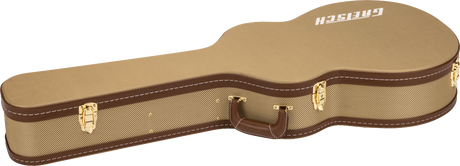 The image shows a hardshell acoustic guitar case with a tan tweed-textured exterior and brown leather trim. It features three gold metal latches and a brown leather handle on the side. The word "GUITAR" is embossed or printed on the top. The case is designed to provide a sturdy, form-fitting protection for an acoustic guitar during transport and storage.