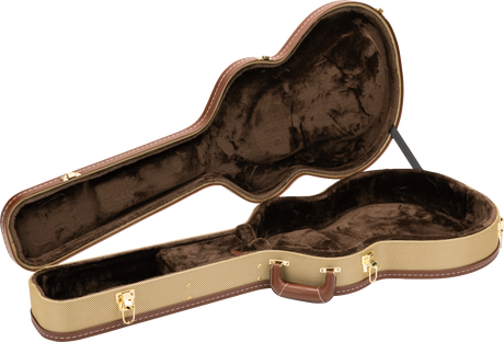 The image shows an open hardshell acoustic guitar case with a tan textured exterior and brown leather-like trim. Its interior has dark brown plush lining and a molded compartment shaped to securely hold the guitar. Gold-toned metal latches, hinges, and an exterior handle are visible. This professional-grade case offers sturdy protection for safe transport and storage of acoustic guitars.