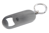 The image shows a sleek, brushed metal Gliga-branded bottle opener keychain with an oval shape and attached keyring. Gliga is a renowned maker of string instruments like violins and cellos. This practical promotional item combines utility with brand visibility, likely given as a gift or sold alongside their instruments to engage musicians and music enthusiasts.