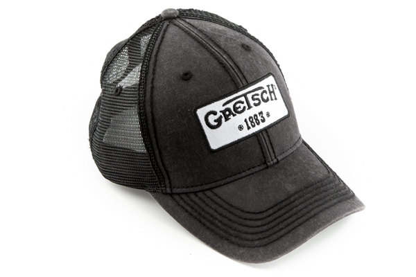 The image shows a dark gray or black distressed trucker hat with mesh backing, featuring a white patch on the front displaying the "Gretsch" logo and "EST 1883." Gretsch is a renowned musical instrument manufacturer known for guitars and drums. This official branded cap is likely promotional merchandise from the company or music stores to promote the Gretsch brand.
