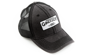 The image shows a dark gray or black distressed trucker hat with mesh backing, featuring a white patch on the front displaying the "Gretsch" logo and "EST 1883." Gretsch is a renowned musical instrument manufacturer known for guitars and drums. This official branded cap is likely promotional merchandise from the company or music stores to promote the Gretsch brand.