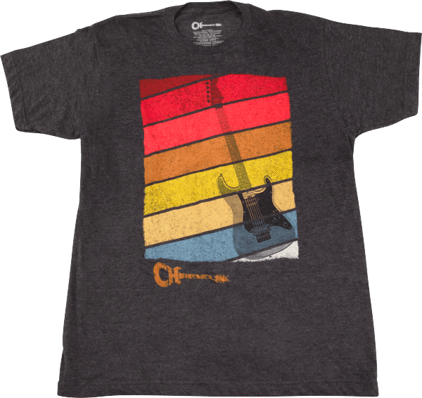 The image shows a dark gray t-shirt with a retro-style graphic of horizontal stripes in red, orange, yellow, and blue, resembling a vintage sunset. Silhouetted against the stripes is an electric guitar outline. Below the design is the "Charvel" logo, indicating official merchandise from the well-known guitar manufacturer popular in rock and metal music.