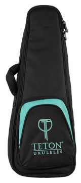 The image shows a black Teton Ukuleles gig bag with teal accents and the Teton logo on the front pocket. It features a padded soft-shell design, a full-length zipper, and a carrying handle. The sleek, modern case is lightweight and portable, designed to protect and transport ukuleles while prominently displaying the stylized "T" logo above the company name.