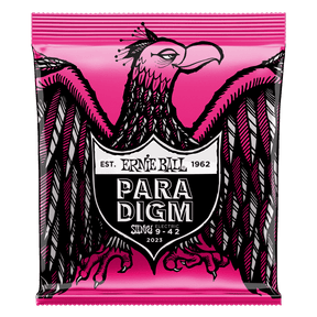 A package of Ernie Ball Paradigm guitar strings with eagle artwork on a pink background