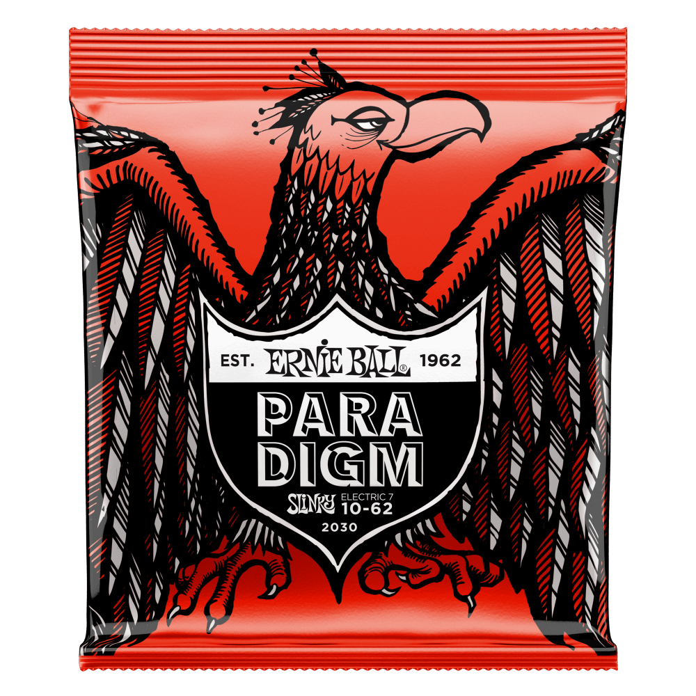 A package of Ernie Ball Paradigm guitar strings with eagle artwork on a red background