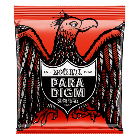 A package of Ernie Ball Paradigm guitar strings with eagle artwork on a red background