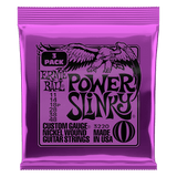 Purple packaging of Ernie Ball Power Slinky guitar strings on a black background