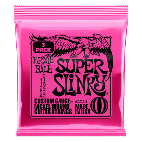 Pink packaging of Ernie Ball Super Slinky guitar strings on a black background