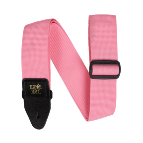 Pink guitar strap with black buckle and gold Ernie Ball logo on a white background