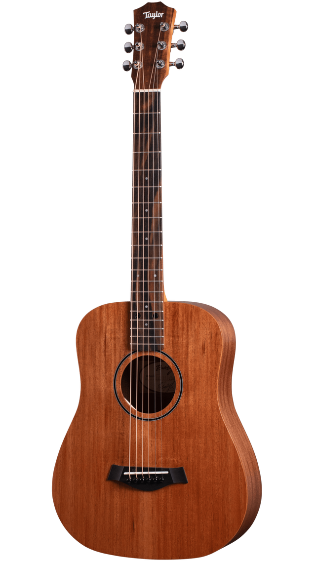 The image shows a Taylor dreadnought-style acoustic guitar with a natural reddish-brown wood finish. It features a 6-string steel setup, chrome tuning pegs, black bridge, traditional soundhole with a simple rosette, and a fretboard with dot markers. The classic dreadnought body highlights Taylor’s quality craftsmanship and balanced tone typical of their reliable, solid wood acoustic guitars.