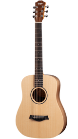 The image shows a Taylor small-bodied acoustic guitar, likely from the Academy or entry-level series. It features a natural spruce top, darker wood back and sides, and a dark rosewood or ebony fretboard. Chrome tuning pegs (3+3), a black bridge, and a round soundhole with a dark rosette are visible. The guitar has a clean, simple design, suitable for beginners to intermediate players and various acoustic styles.