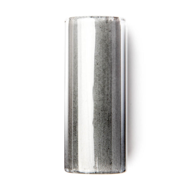 A cylindrical glass guitar slide on a white background.