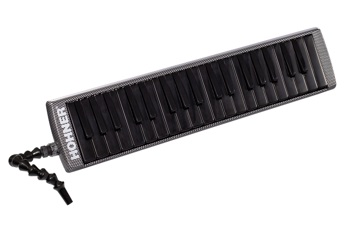 The image shows a melodica, a wind instrument with a piano-style keyboard of about 37 keys. It has a black flexible tube mouthpiece, a sleek black and silver/carbon fiber-look casing, and visible "ROCK" branding. Played by blowing air and pressing keys, it uses free reeds to produce sound. This modern model appears designed for professional use, popular in genres like reggae and educational music.