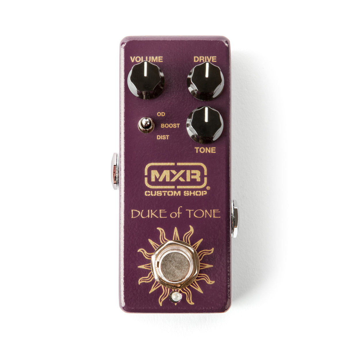 The image shows an MXR Custom Shop "Duke of Tone" overdrive/distortion guitar pedal in a purple/burgundy enclosure with gold lettering. It has three knobs: Volume (top left), Drive (top right), and Tone (bottom right), plus a toggle switch labeled "OD/BOOST/DIST" for selecting overdrive, boost, or distortion modes. The pedal features MXR’s compact design with a sun-like graphic around the footswitch and input/output jacks on the sides.