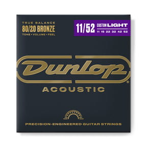 The image shows a package of Dunlop Acoustic guitar strings made with 80/20 Bronze for balanced tone, volume, and feel. It’s a Custom Light set (11-52 gauge) with precision-engineered strings (11, 15, 22, 32, 42, 52). The packaging features a dark charcoal background, gold Dunlop logo, and a purple accent bar highlighting the gauge, exuding a professional, premium look.
